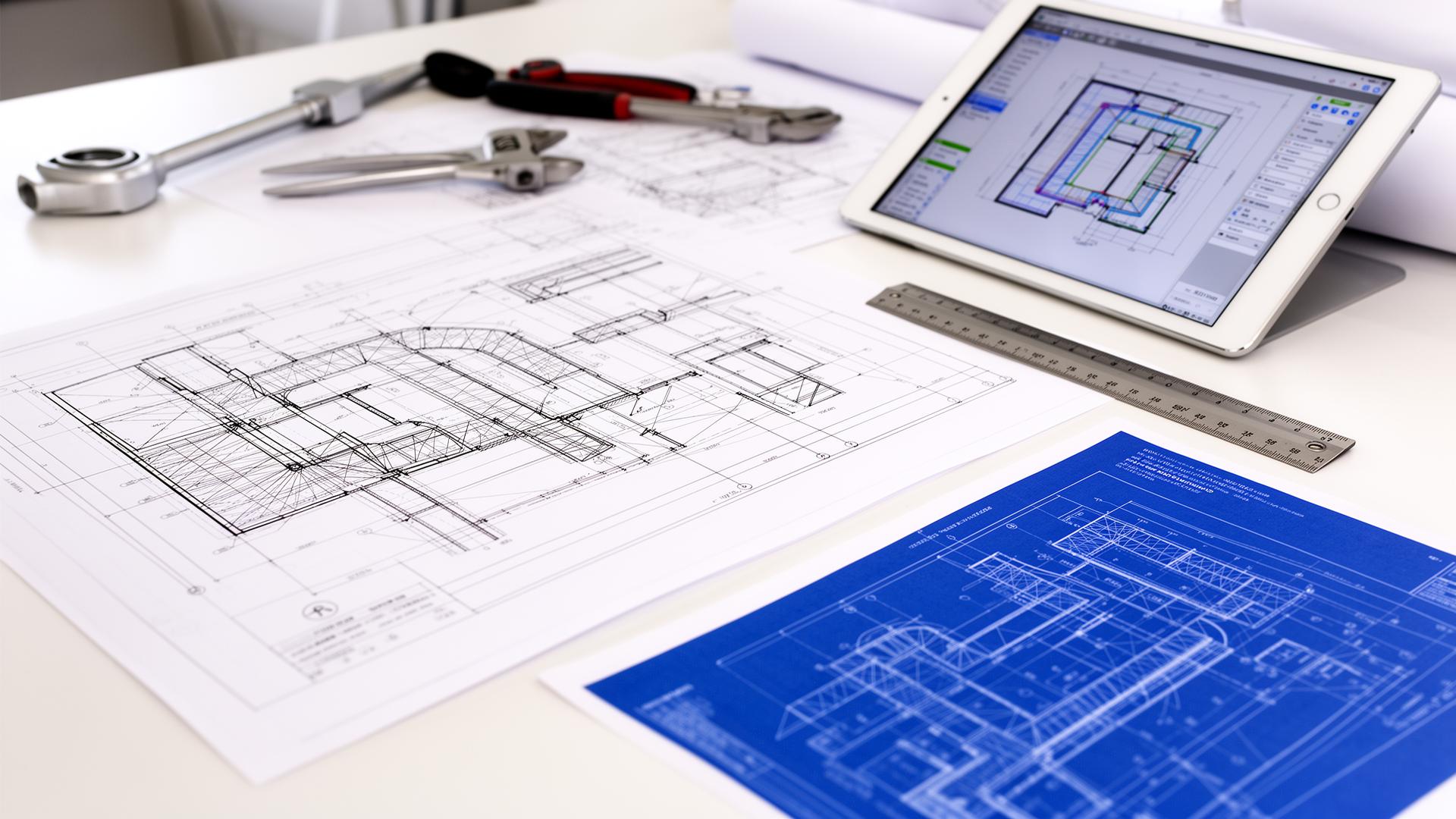HVAC engineering blueprints and technical drawings on desk